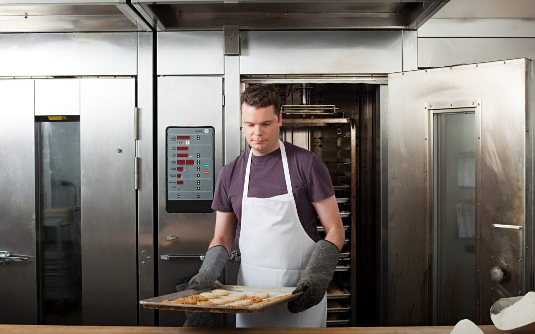 male chef baking cookies in kitchen - Commercial Catering Equipment Gloucester